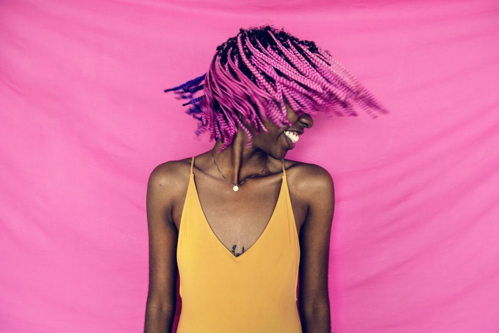 Girl shaking her pink braided hair