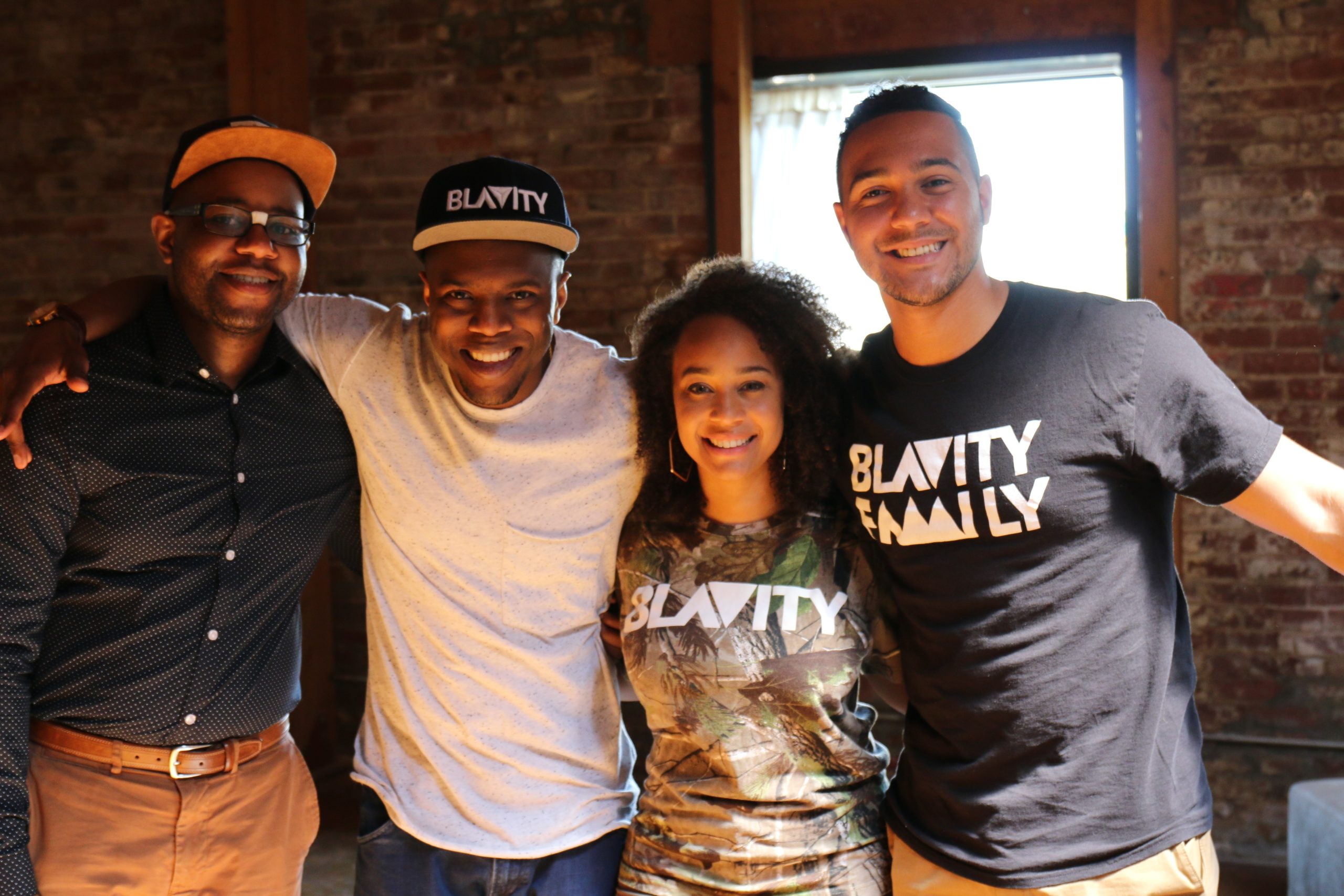 The four founders of Blavity Inc. standing together with smiles on their faces