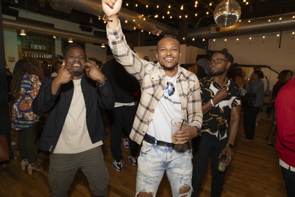 Young men of color celebrating with one another at a Blavity Inc. party