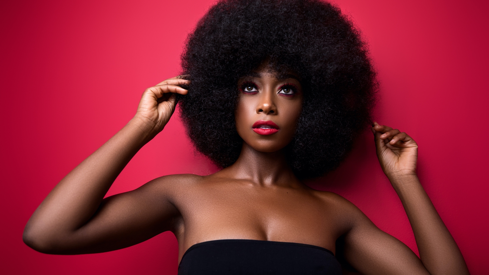 Beautiful Black woman wearing a fro being highlighted in a Black History Month campaign