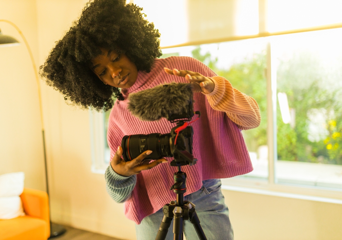 BIPOC influencer setting up camera to create public health messaging content