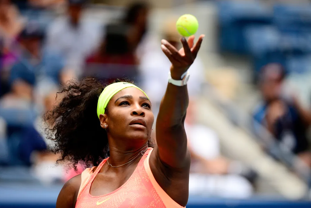 Serena Williams on the tennis court preparing to play and representing Black women in sports